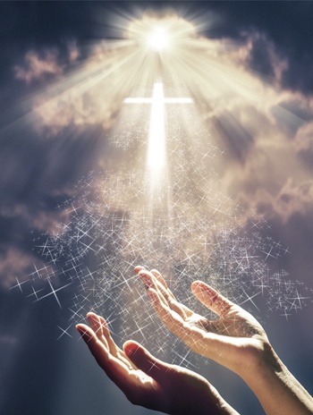 Hands reaching out toward heaven with a radiant shining cross in the clouds. Prayer of salvation concept.