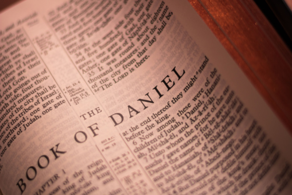 The book of Daniel is open in the Bible. Biblical Bedtime Story concept.