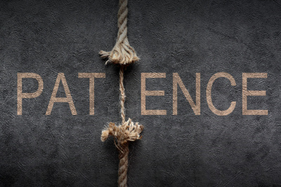 A rope stretched to symbolize patience, represented on a black background. Should you pray for patience, concept.