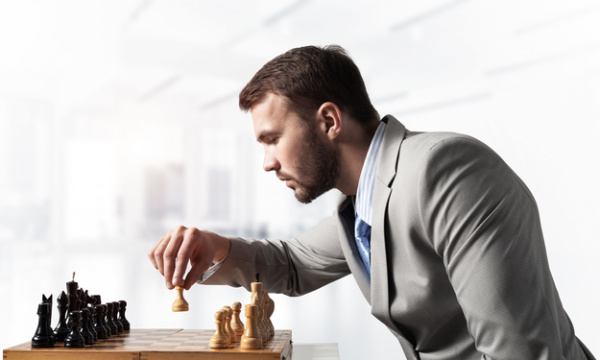 A businessperson arranging a chess piece on a chessboard is operating strategically and preparing for operation tactics and strategies. Concept, Bible verses for different situations.