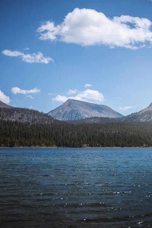 A vast expanse of water bordered by mountains in the distance. Concept, calmness in the storm.