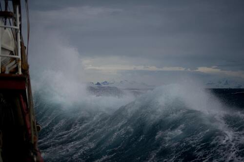 During the day, a massive wave is visible—concept, calmness in the storm.