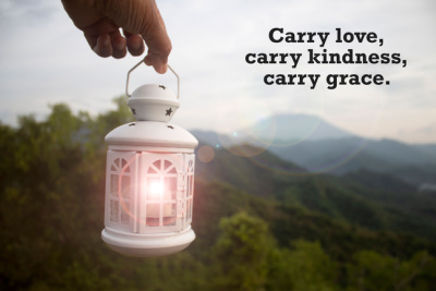 The quote about life being inspirational and motivational emphasizes the importance of carrying love, kindness, and grace. It is depicted with an image of a person holding a white lantern on a mountain background.